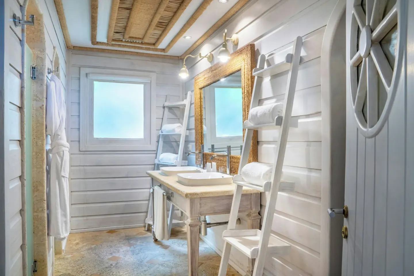 Oceanside villa bathroom with double sinks at Sanctuary Cap Cana, a Luxury Collection Resort.