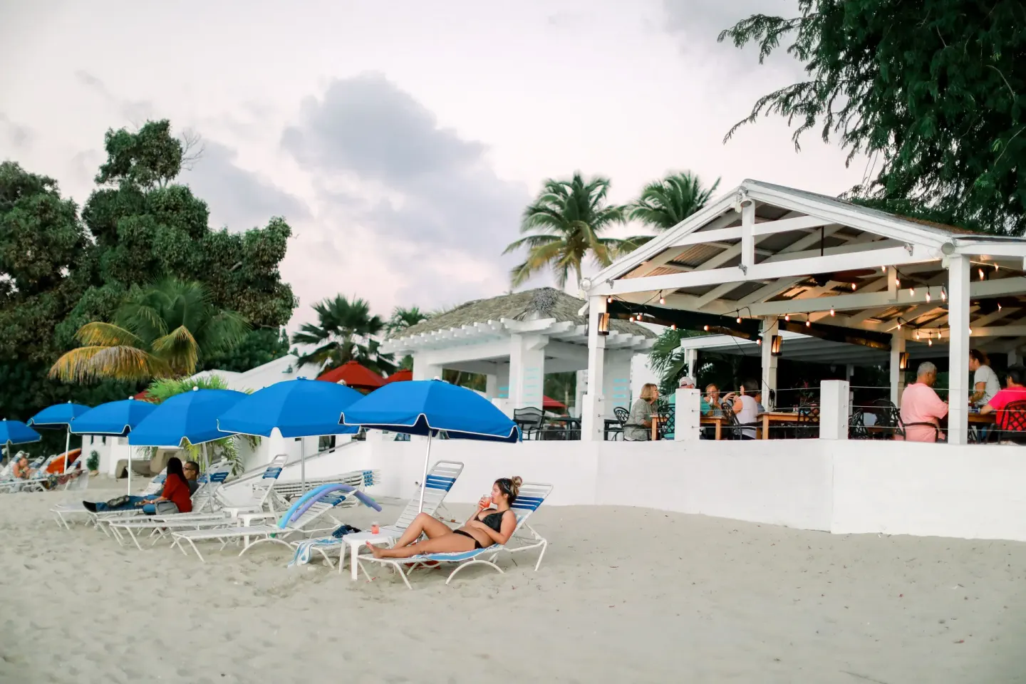 Beach lounge chairs and open-air dining terrace at Sand Castle on the Beach.