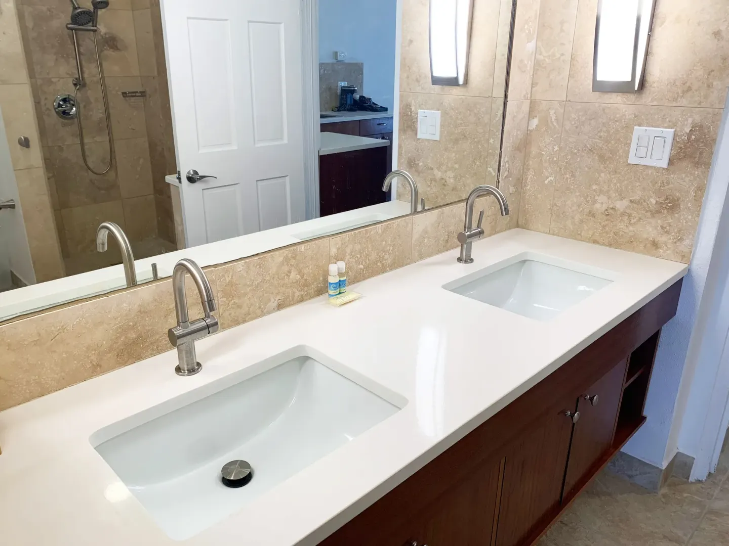 Guest bathroom vanity with two sinks and a large mirror at Sand Castle on the Beach.
