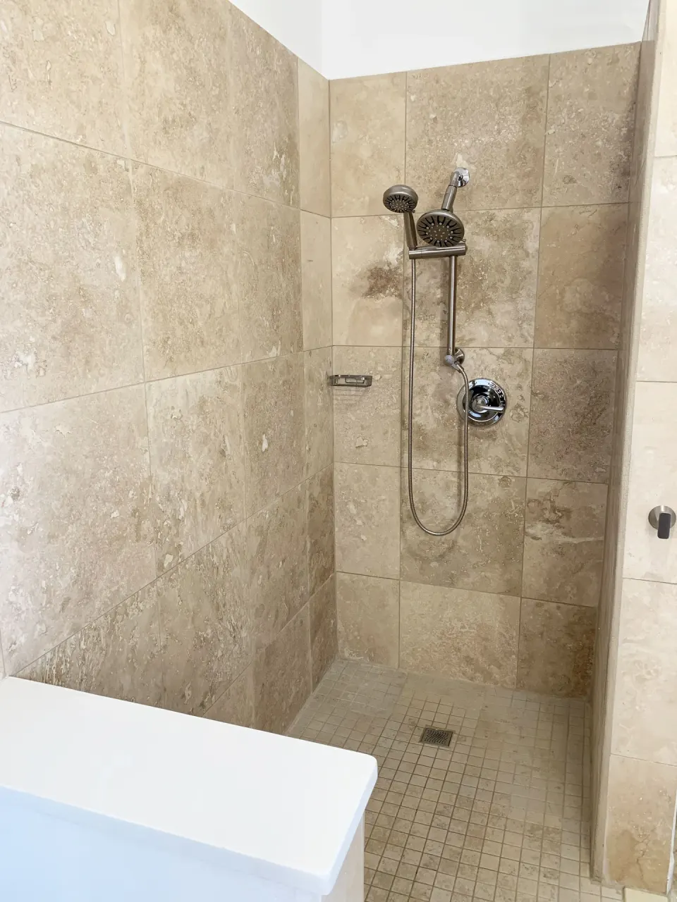 Walk-in tiled shower with dual shower heads at Sand Castle on the Beach.