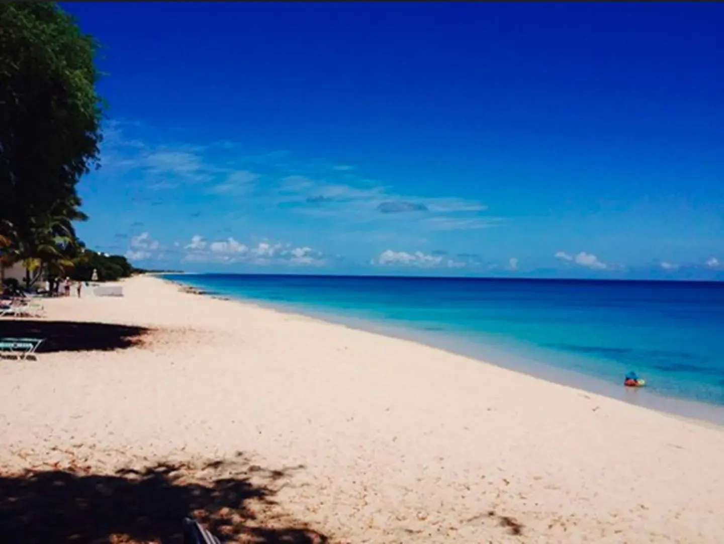 Long sandy shoreline and blue water at Sand Castle on the Beach.