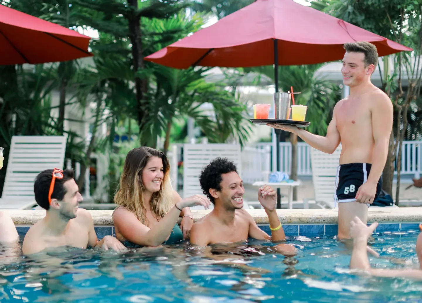 Guests in the pool are served drinks at Sand Castle on the Beach.