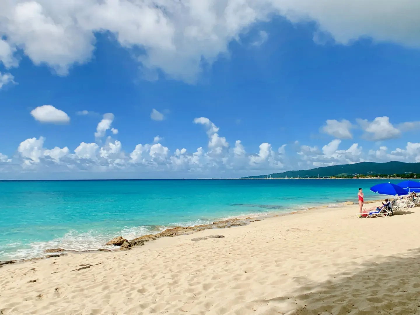 Wide sandy beach with turquoise water at Sand Castle on the Beach.