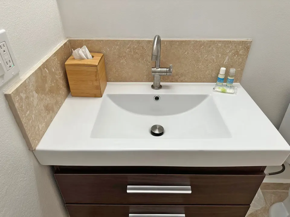 Dolphin Villa bathroom vanity with sink and bath amenities at Sand Castle on the Beach.