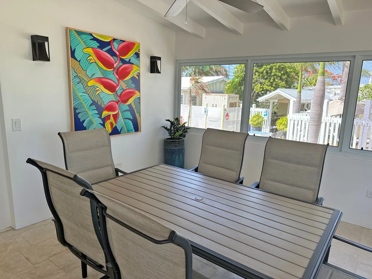 Dolphin Villa dining area with large table and garden-facing windows at Sand Castle on the Beach.