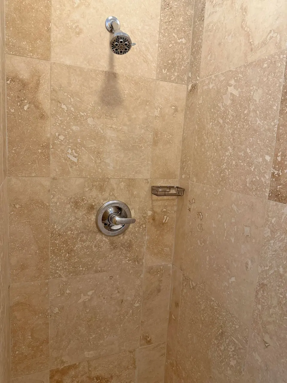 Dolphin Villa tiled shower with wall-mounted showerhead at Sand Castle on the Beach.