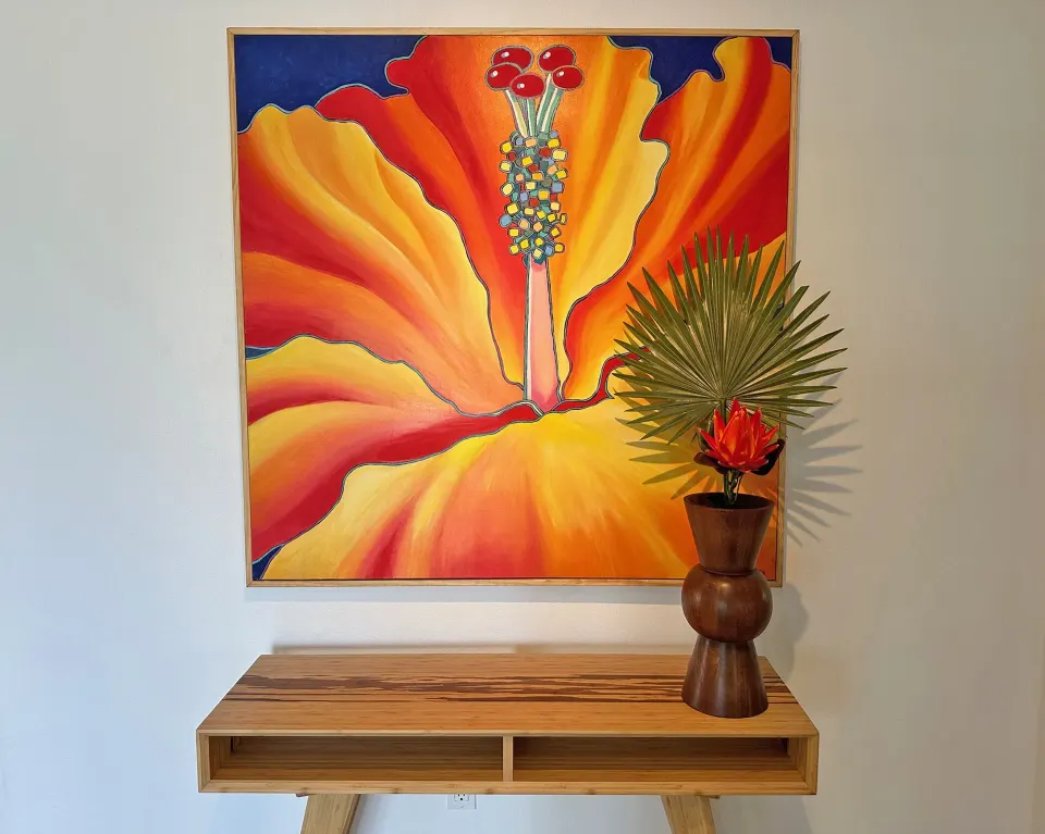 Floral wall art and console table in the Dolphin Villa at Sand Castle on the Beach.