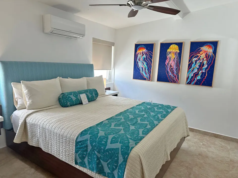 Dolphin Villa bedroom at Sand Castle on the Beach with a king bed and jellyfish wall art.