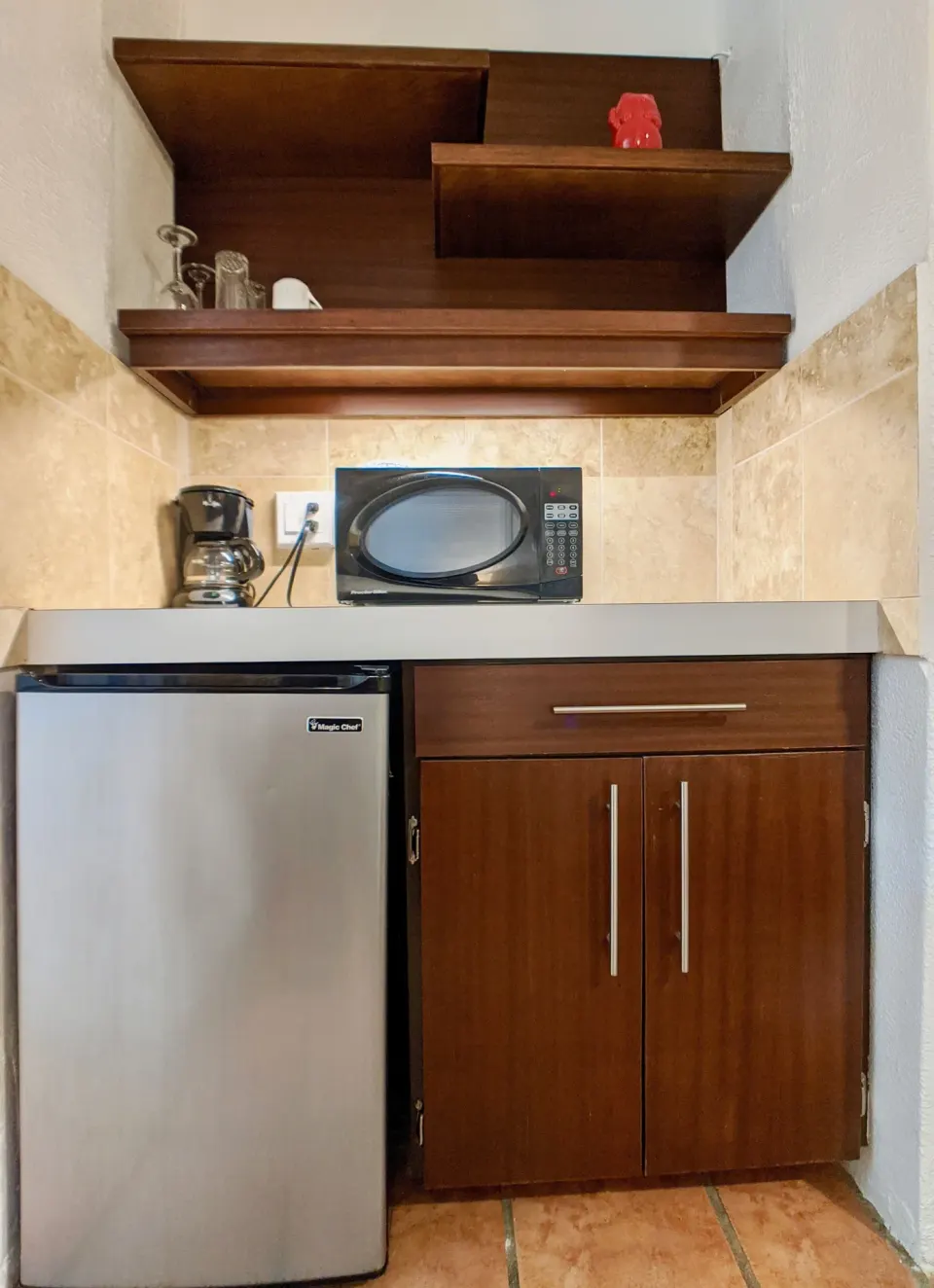 Standard Room kitchenette with mini fridge and microwave at Sand Castle on the Beach.
