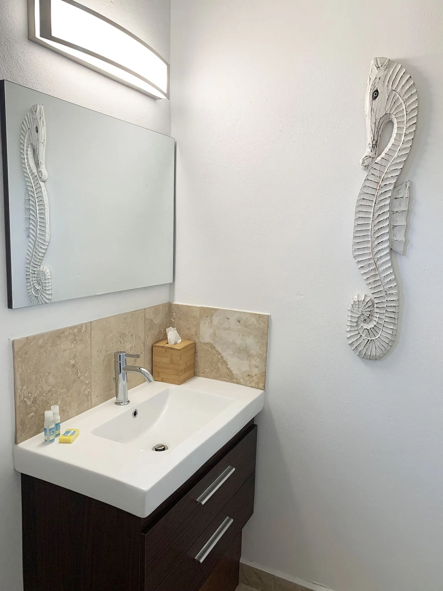Garden View Suite bathroom with seahorse décor at Sand Castle on the Beach showcasing coastal charm in Ocho Rios.