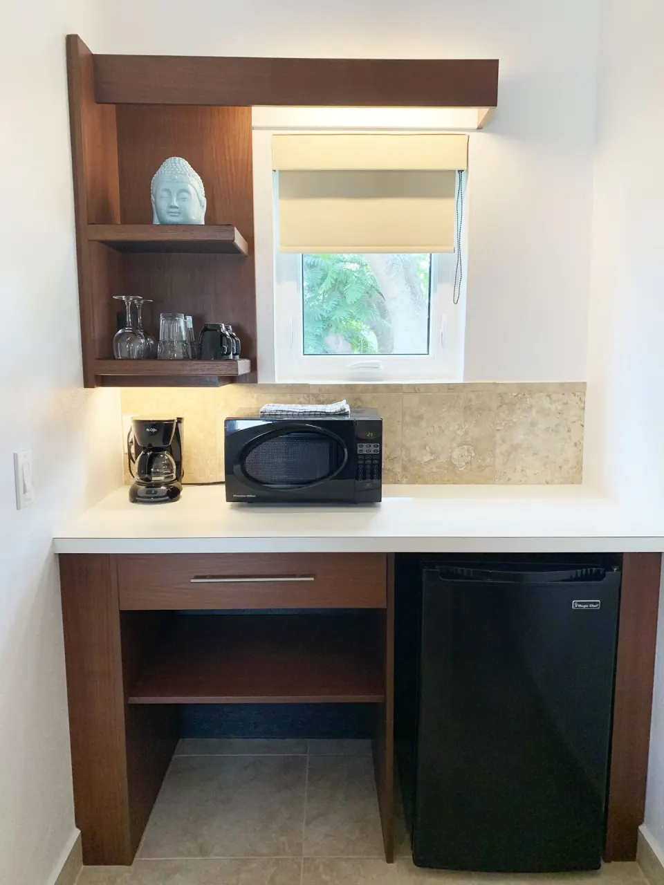 Studio kitchenette with microwave, coffee maker, and mini fridge at Sand Castle on the Beach.