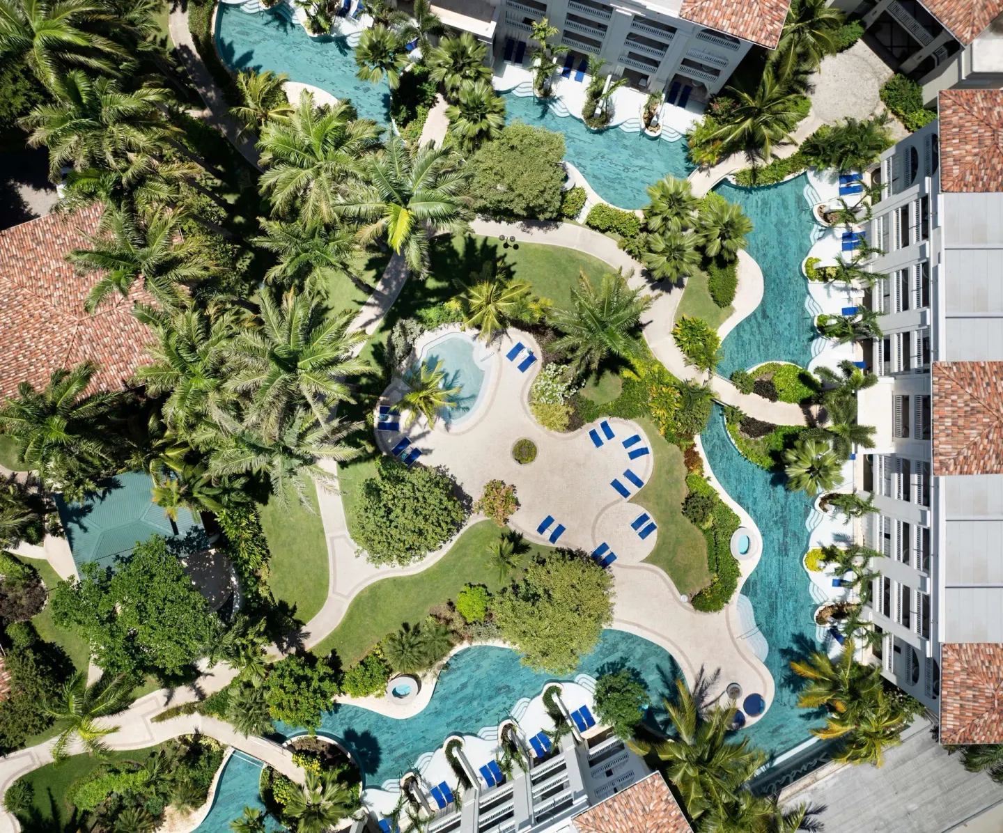 Aerial view of lagoon pools, gardens, and guest buildings at Sandals Barbados.