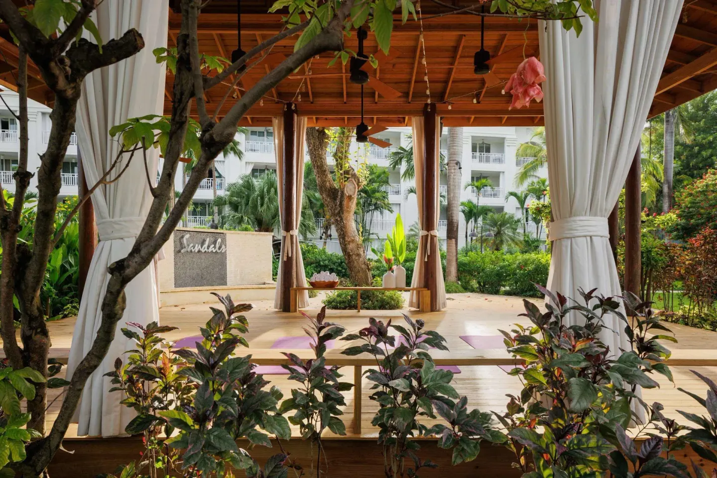 Open-air garden pavilion with yoga mats at Sandals Barbados.