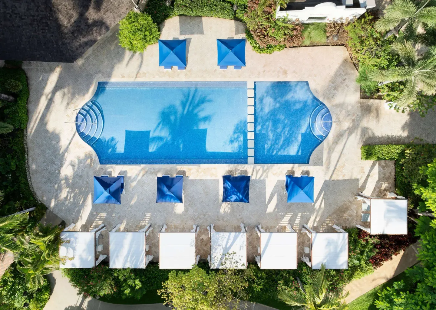 Overhead view of a rectangular pool with cabanas at Sandals Barbados.