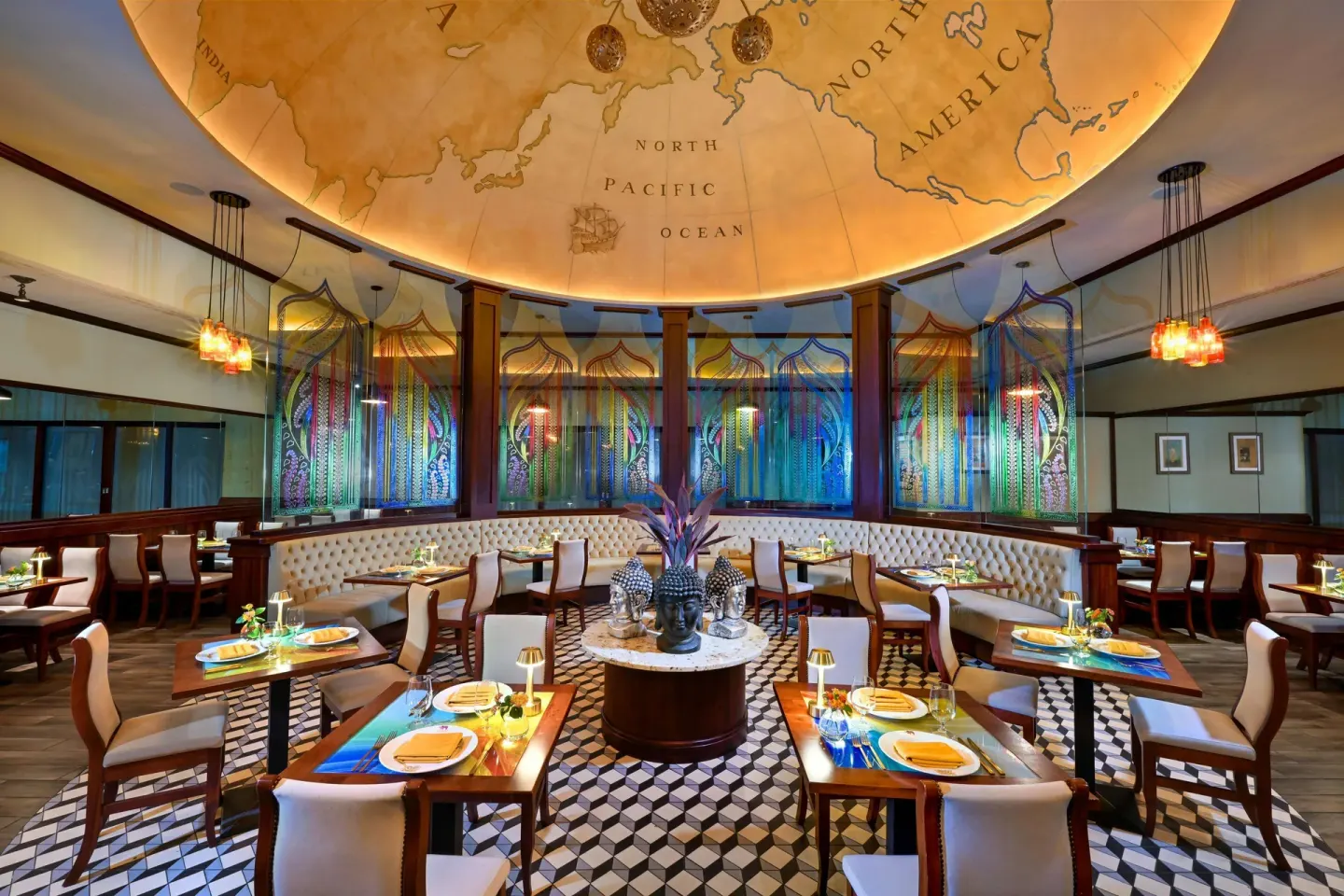 Colorful Bombay Club dining room with set tables at Sandals Barbados.