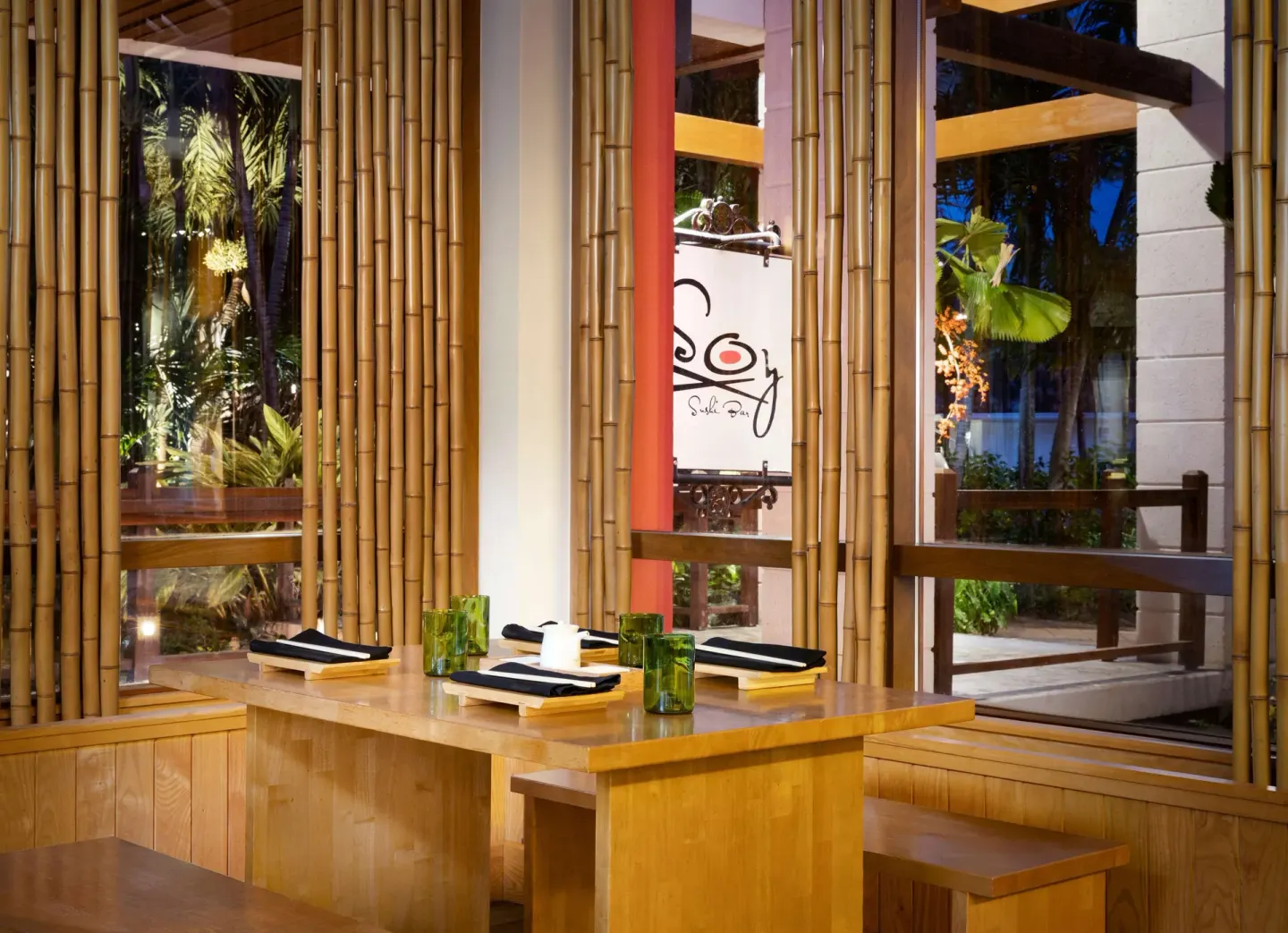 Wooden sushi bar seating with bamboo accents inside Kimonos at Sandals Barbados.