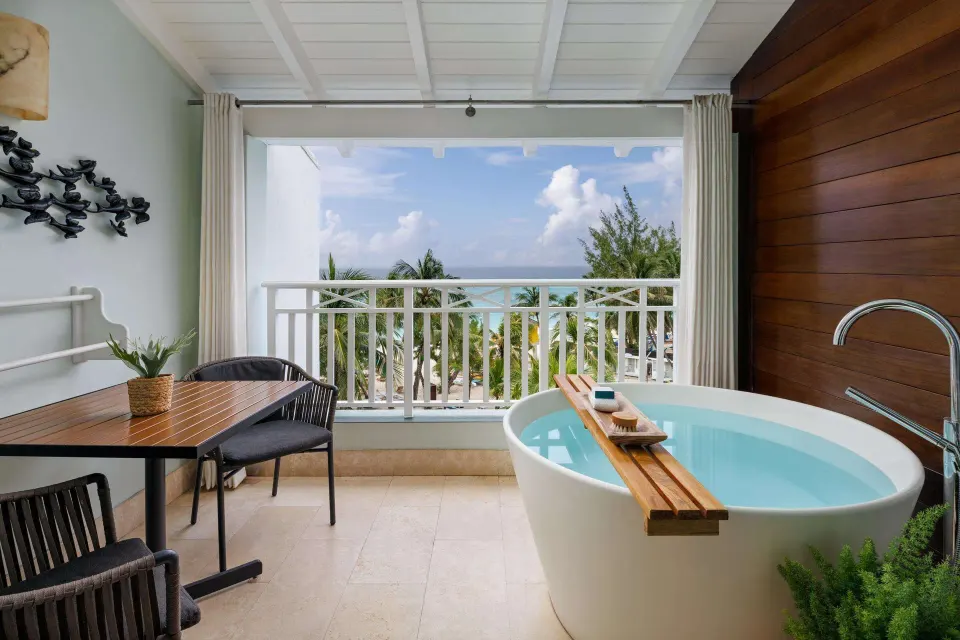 Club Penthouse balcony soaking tub with ocean view at Sandals Barbados.