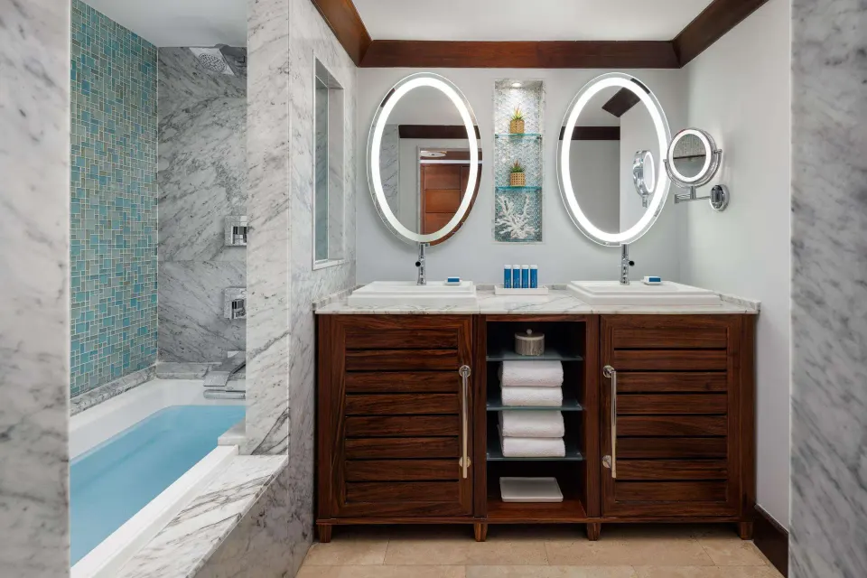 Club Penthouse bathroom with double vanity and tub at Sandals Barbados.