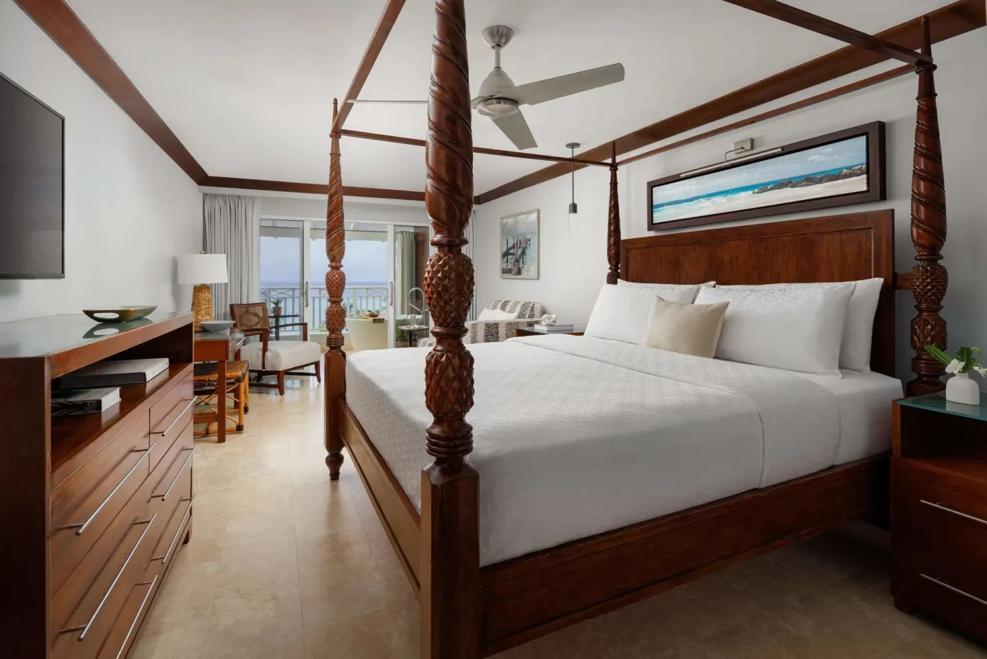 Club Penthouse ocean view bedroom with four-poster bed at Sandals Barbados.