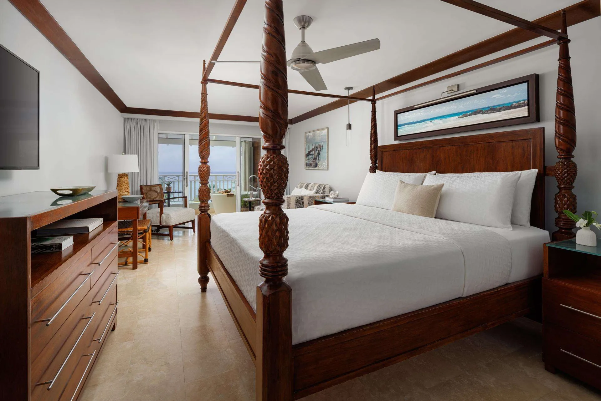 Club Penthouse ocean view bedroom with four-poster bed at Sandals Barbados.