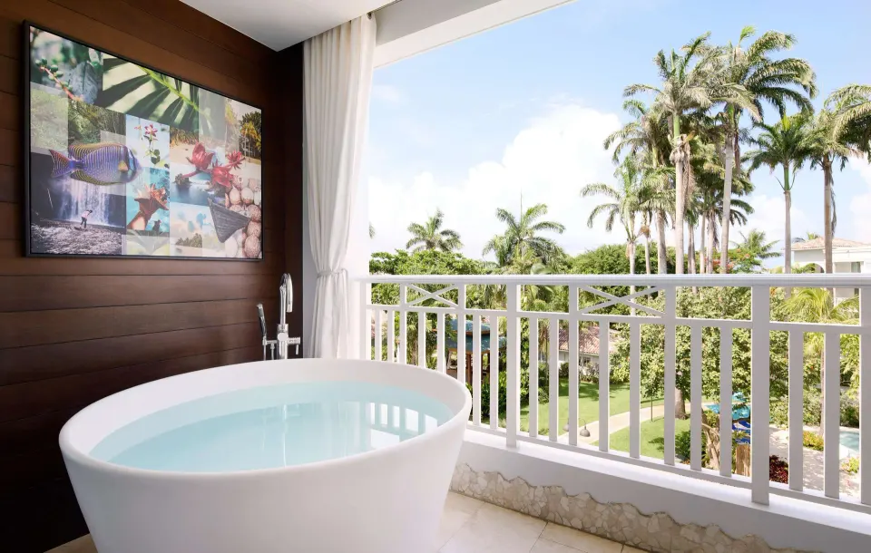 Balcony soaking tub with palm garden view at Sandals Barbados