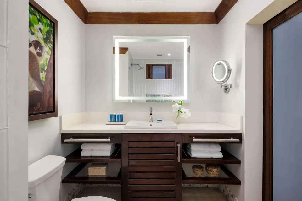 Bathroom vanity with illuminated mirror in a Luxury Room at Sandals Barbados.