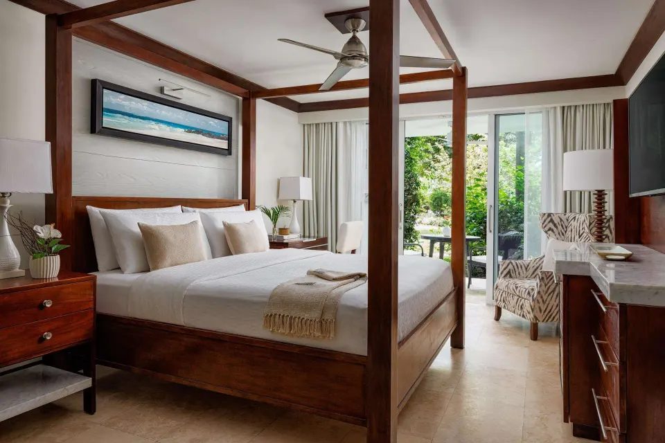 Garden-view Luxury Room with king bed and walkout patio at Sandals Barbados.