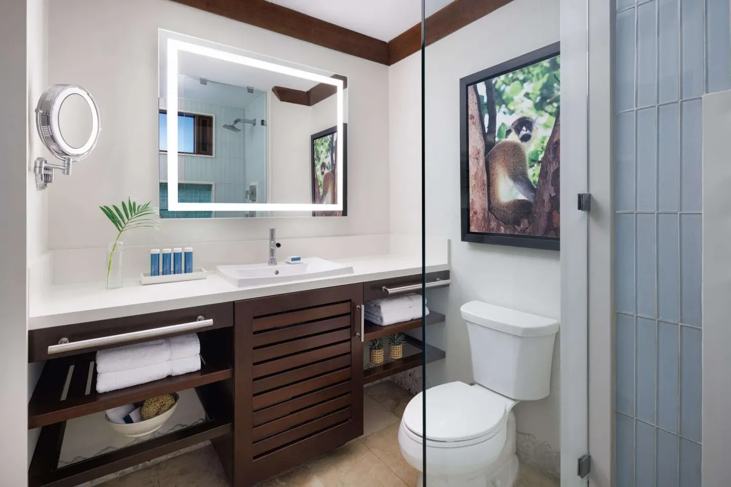 Caribbean Grand Luxe bathroom with vanity, toilet, and glass shower at Sandals Barbados.
