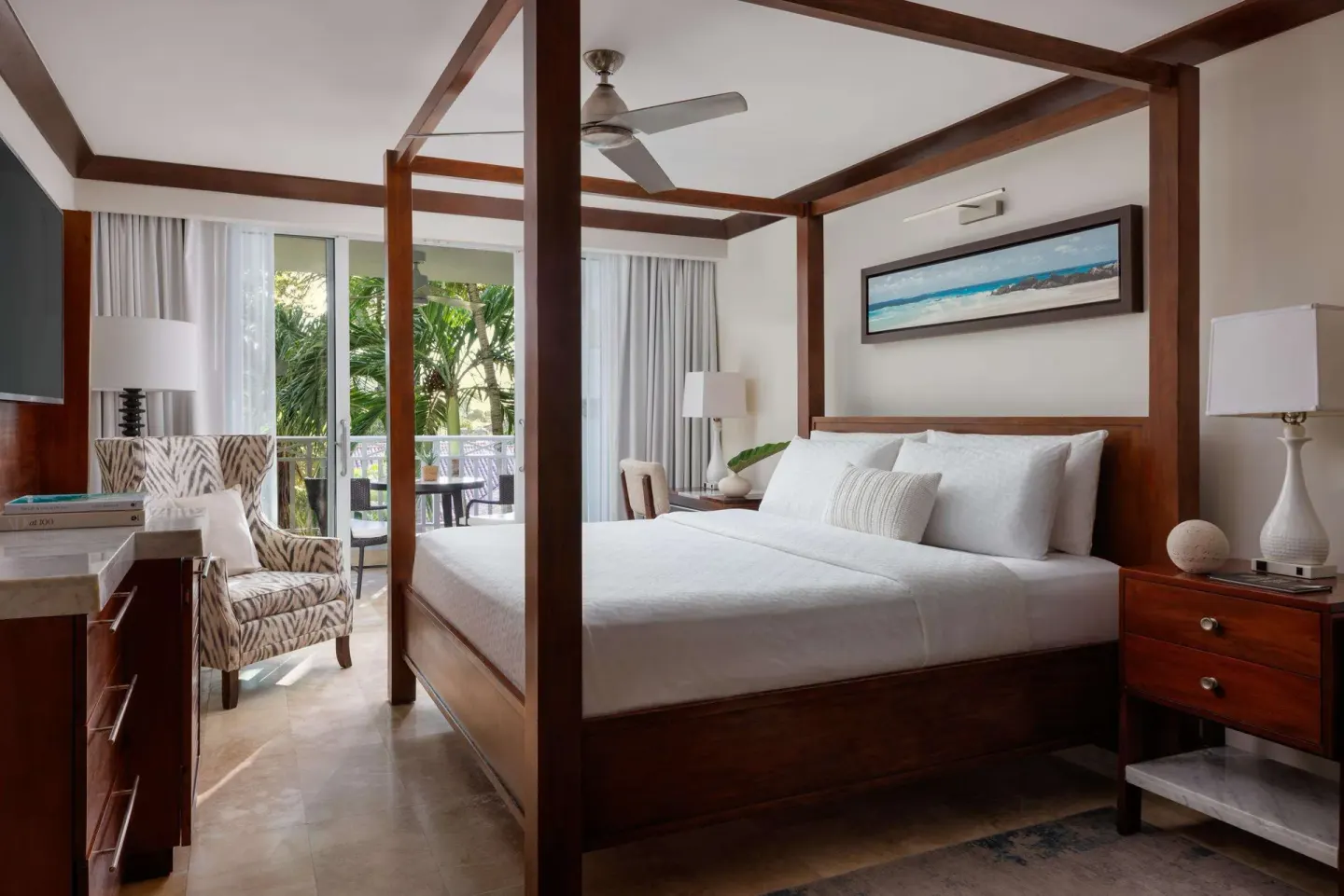 Caribbean Grand Luxe king bedroom with balcony and garden greenery at Sandals Barbados.