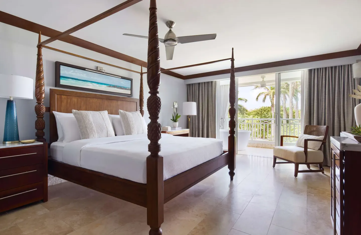 Four-poster king bedroom with balcony view at Sandals Barbados.