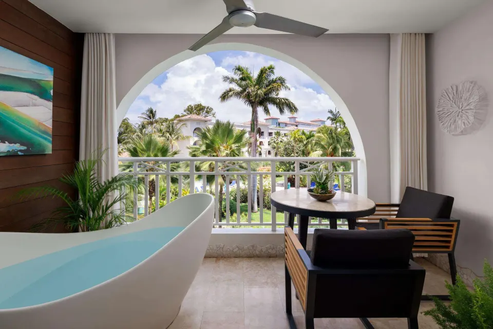 Private balcony with soaking tub and garden view at Sandals Barbados.