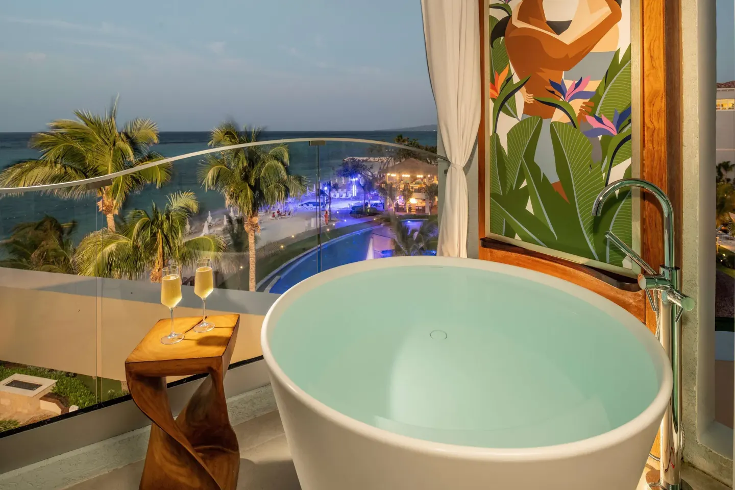 Balcony soaking tub with ocean and pool view at Sandals Dunns River.