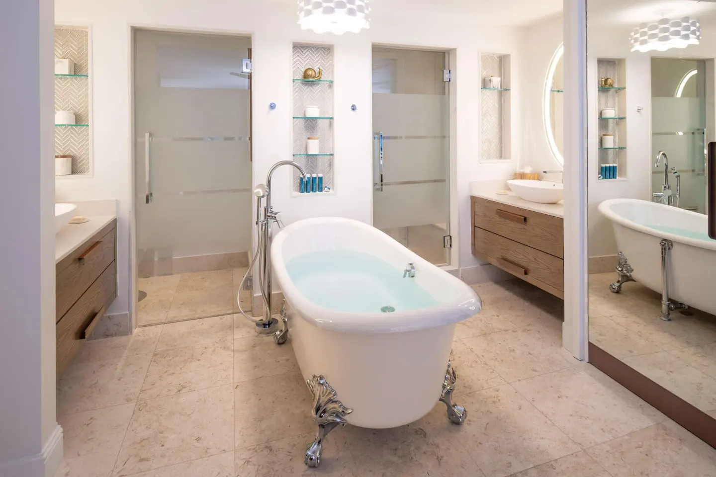 Clawfoot tub bathroom with vanities and glass showers at Sandals Dunns River.