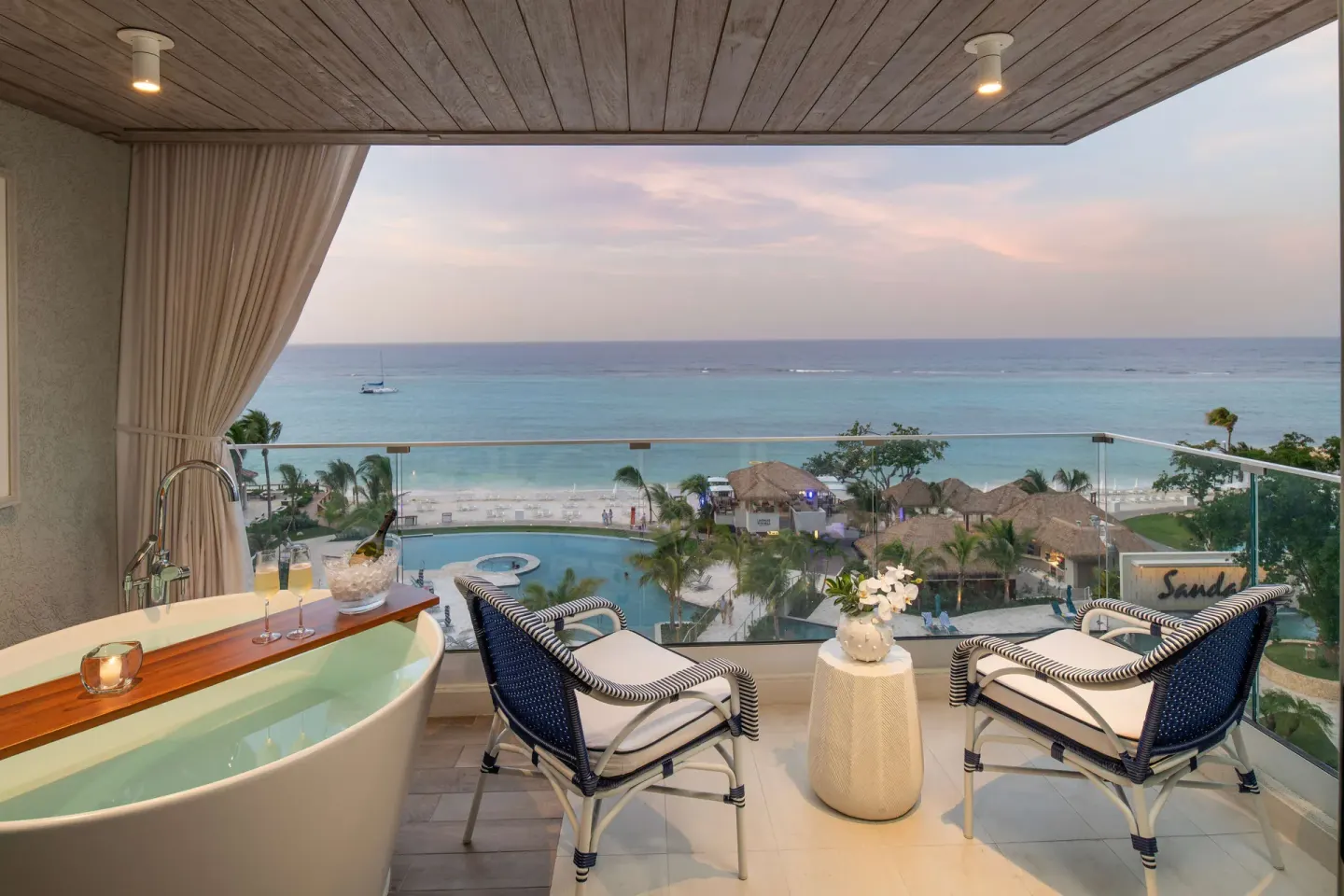 Ocean-view balcony with soaking tub at Sandals Dunns River.