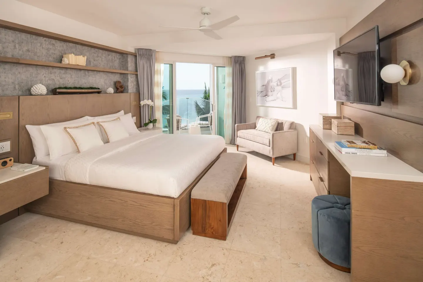 Ocean-view king bedroom with balcony doors at Sandals Dunns River.