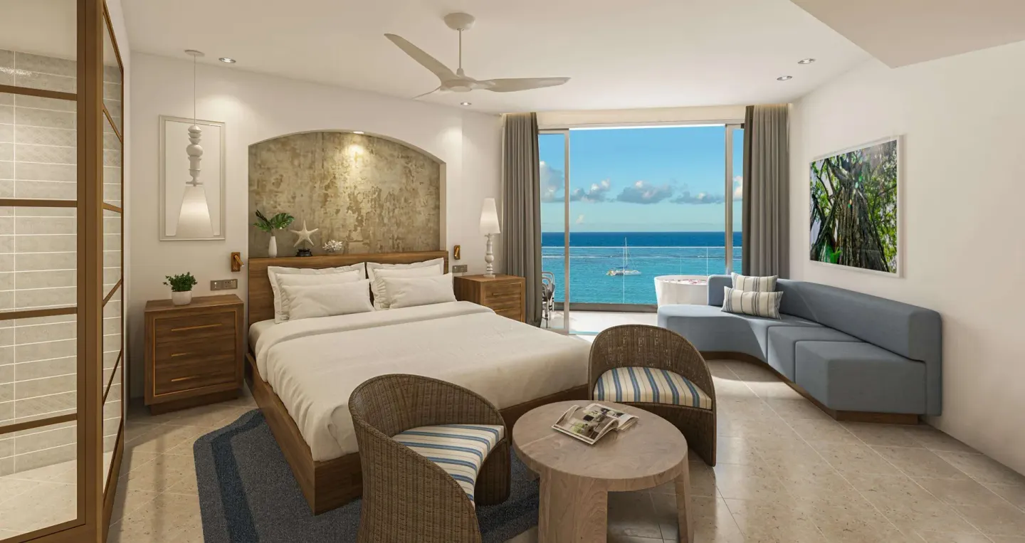 Oceanfront king-bed room with sofa and balcony at Sandals Dunns River.