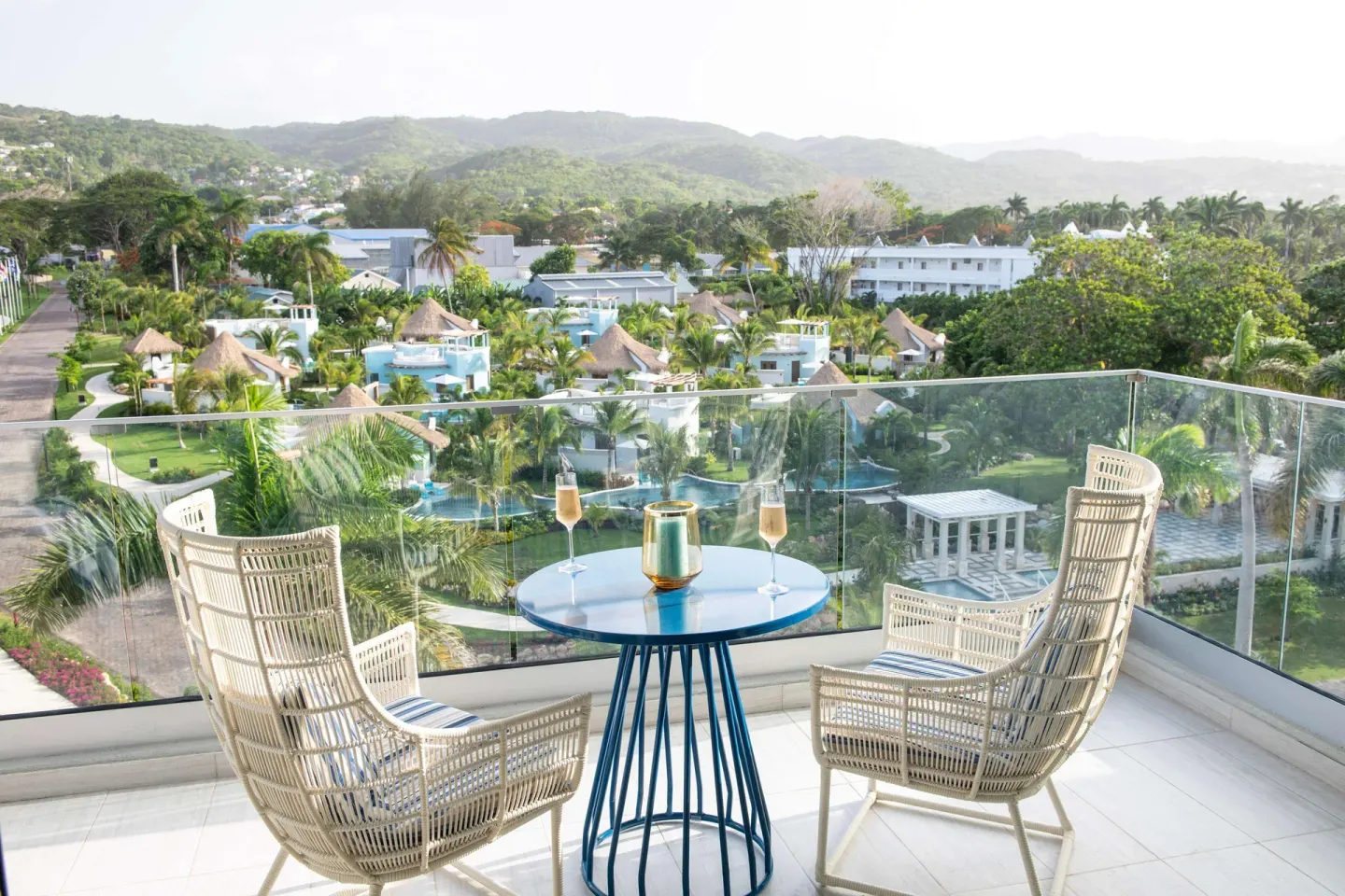 Balcony seating overlooking resort gardens at Sandals Dunns River.