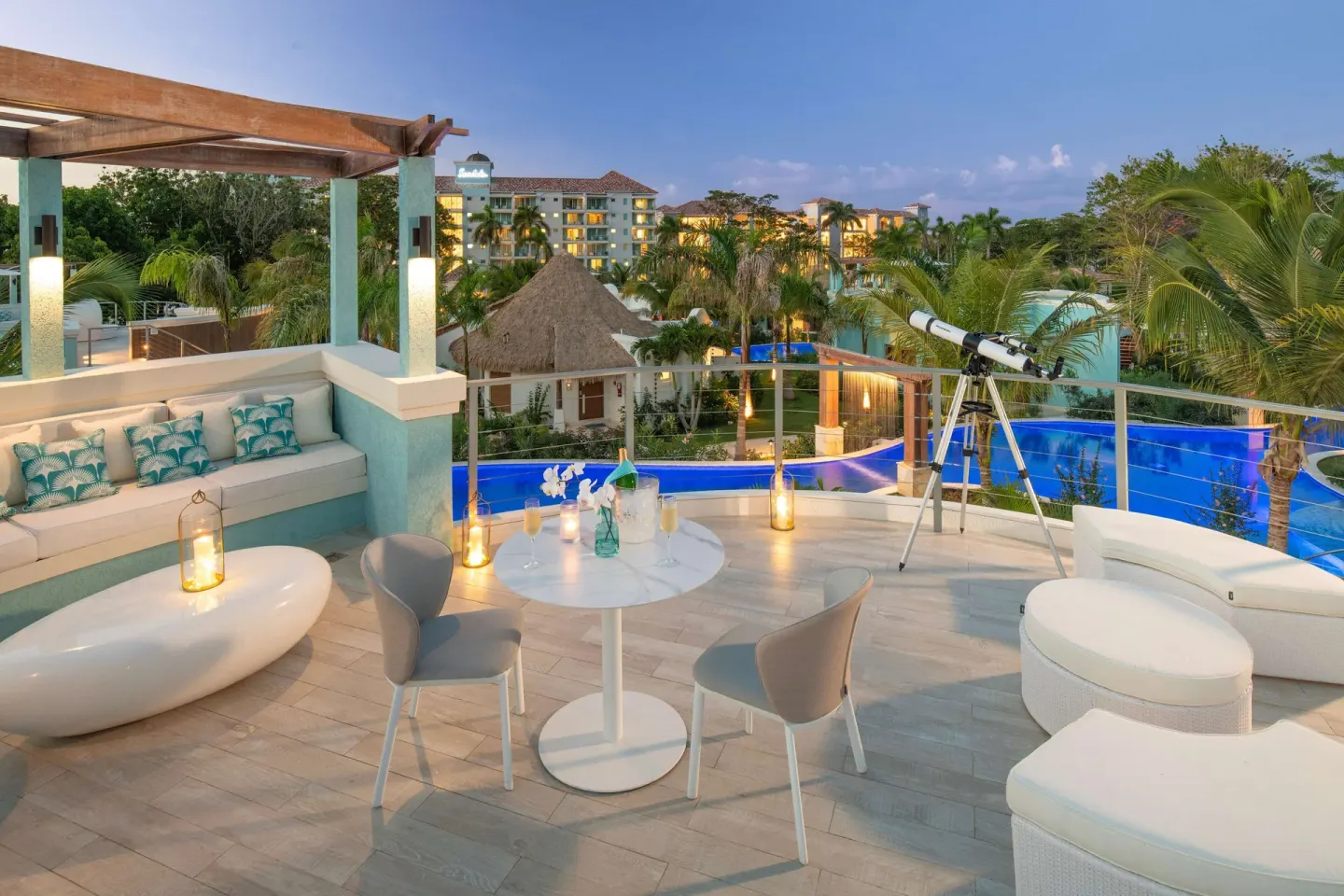 Rooftop terrace with lounge seating and pool views at Sandals Dunns River.
