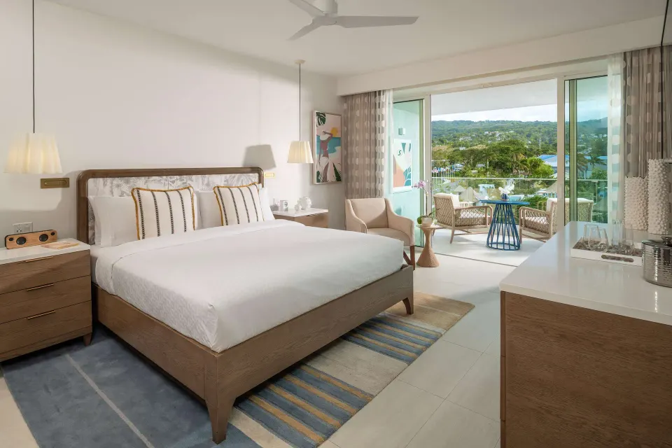 Luxury Room king bed with balcony and garden view at Sandals Dunns River.