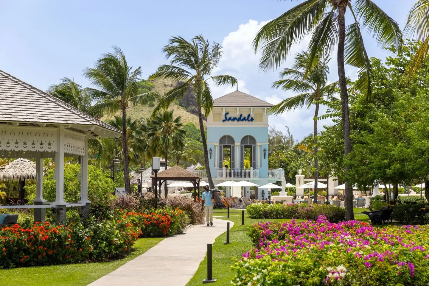 Garden walkway, palms and pastel building at Sandals Grande St. Lucian.