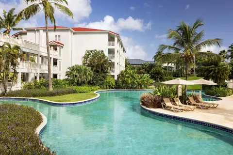 Lagoon pool with loungers and resort buildings at Sandals Grande St. Lucian.