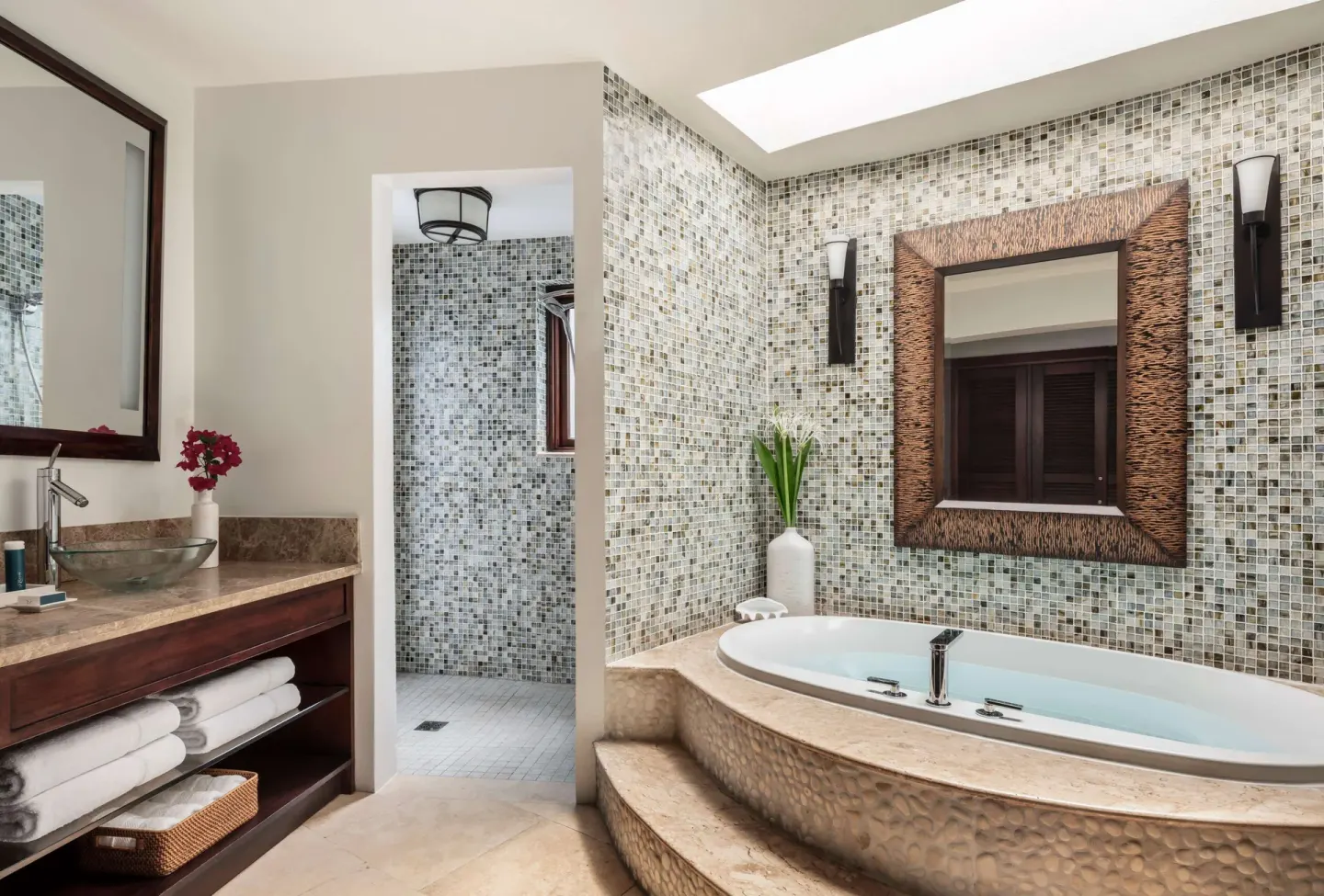 Bathroom with oval soaking tub and mosaic tile at Sandals Grande St. Lucian.