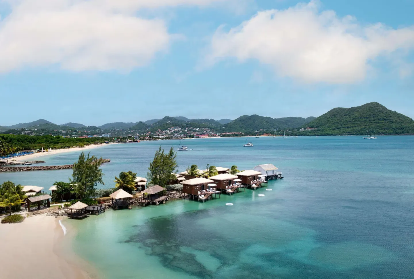 Overwater bungalows and blue bay at Sandals Grande St. Lucian.