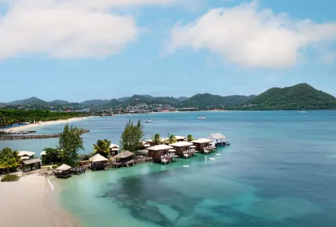 Overwater bungalows and blue bay at Sandals Grande St. Lucian.
