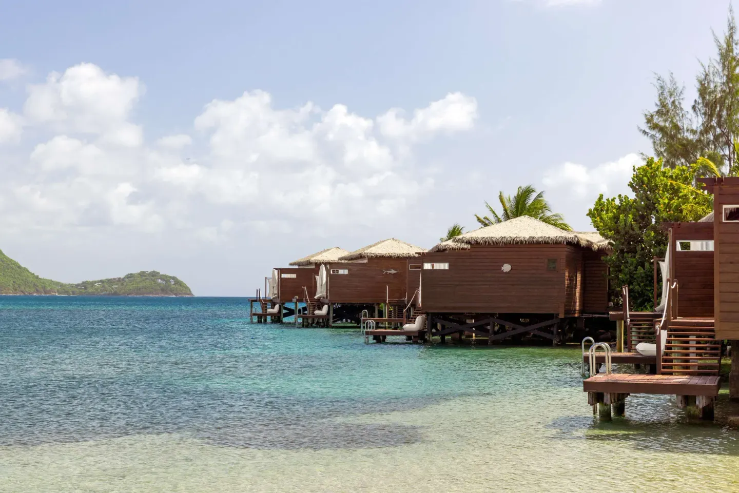 Overwater bungalows above turquoise water at Sandals Grande St. Lucian.