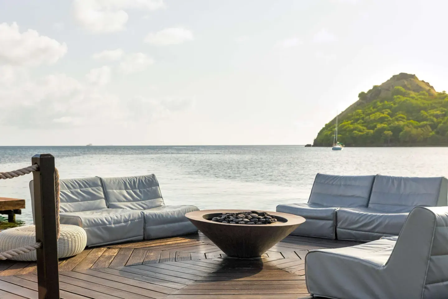 Waterfront lounge seating and fire bowl at Sandals Grande St. Lucian.