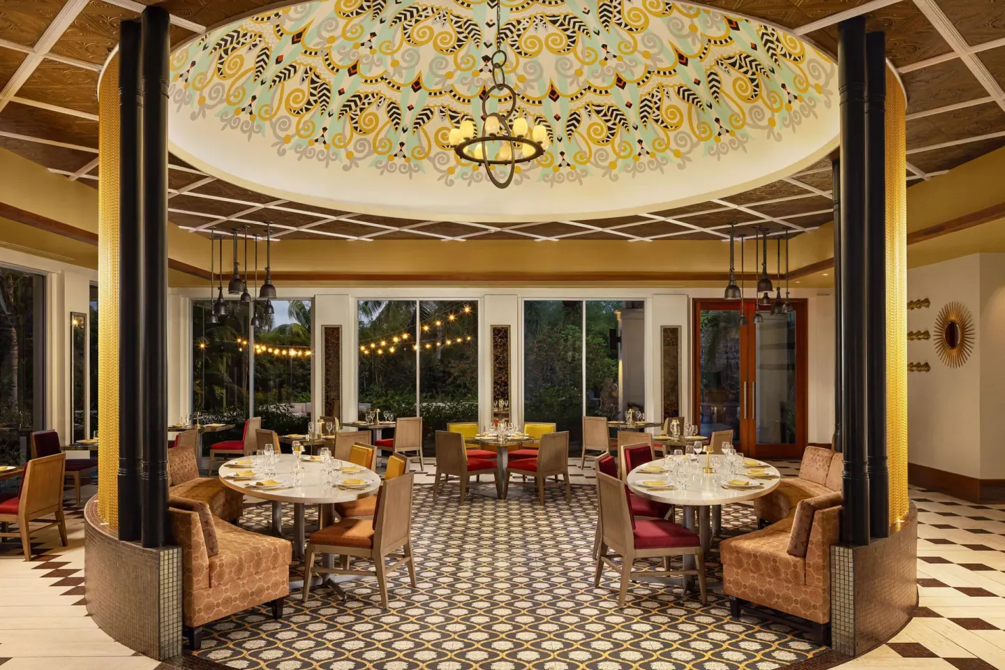 Colorful restaurant dining room with round tables at Sandals Grande St. Lucian.