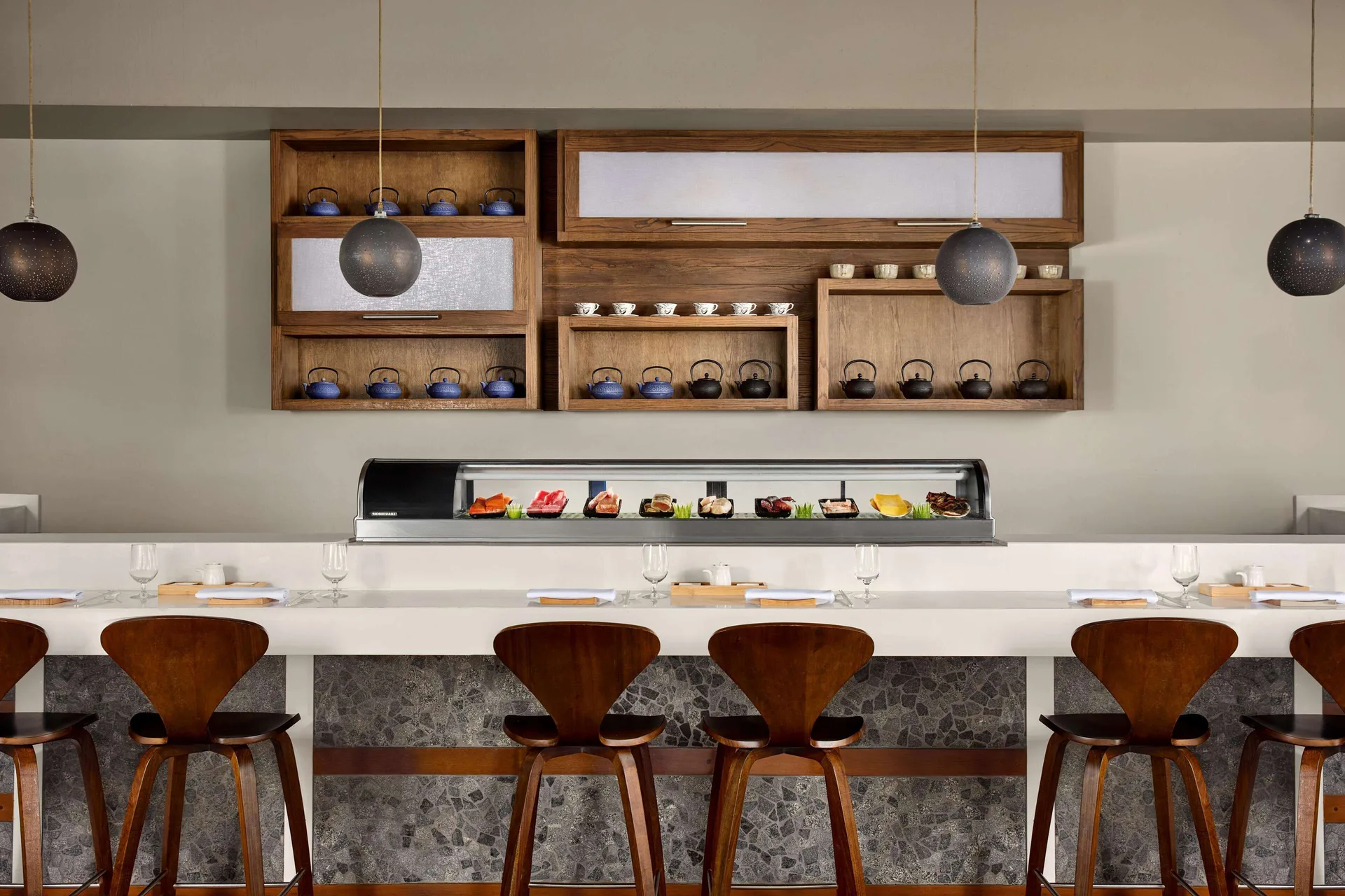 Sushi bar with display case and teapots at Soy at Sandals Grande St. Lucian.