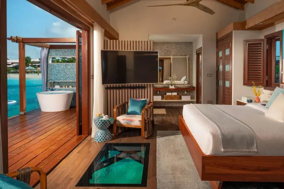 Caribbean Beachview Club Level walkout room with king bed and deck at Sandals Grande St. Lucian.