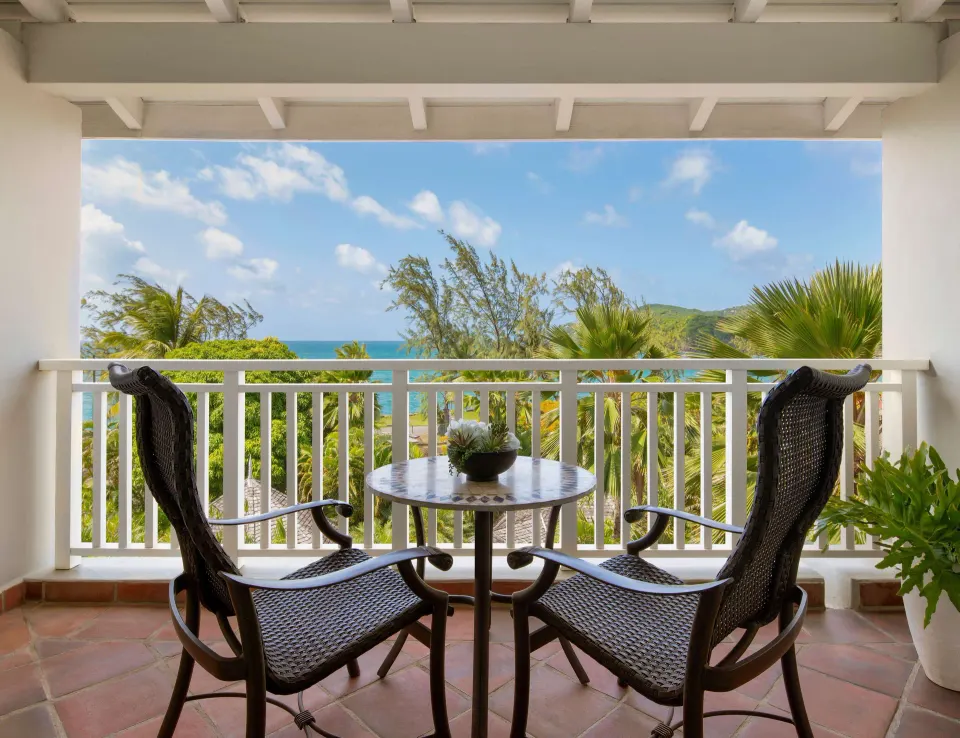 Ocean-view balcony with chairs at Sandals Grande St. Lucian.